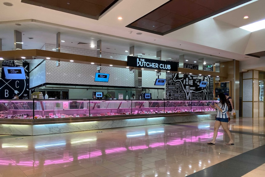 Meat is on display in a butcher shop inside a shopping centre.