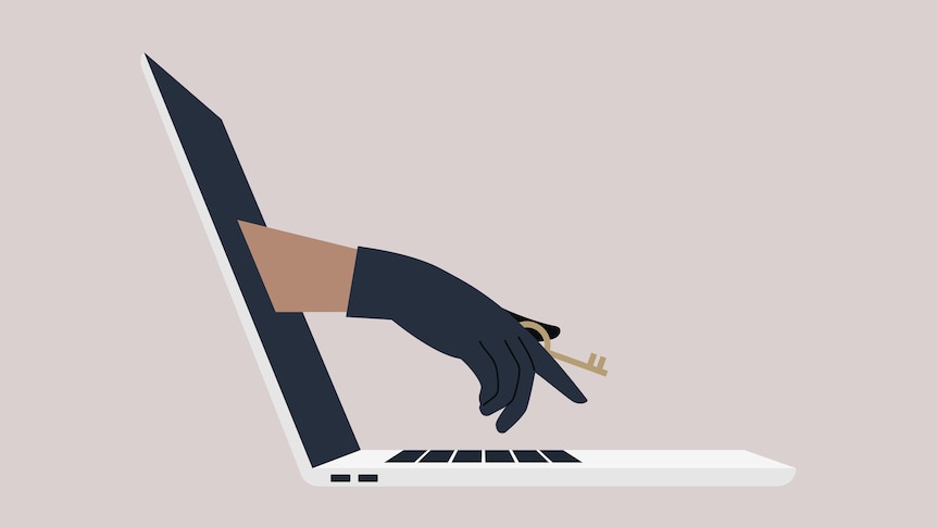 A hand in a black leather glove holding an access key reaching through a laptop screen.