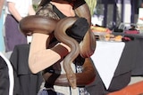 brown snake wrapped around woman's shoulders