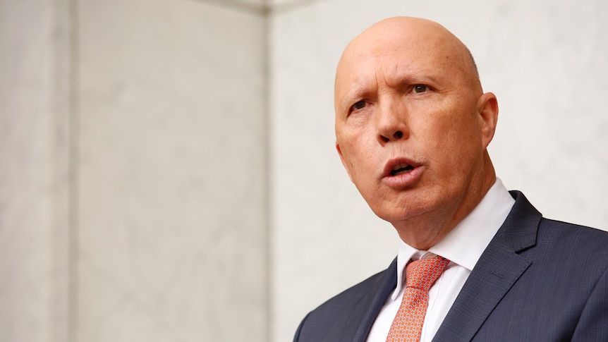 Peter Dutton wearing a suit and tie speaking to media
