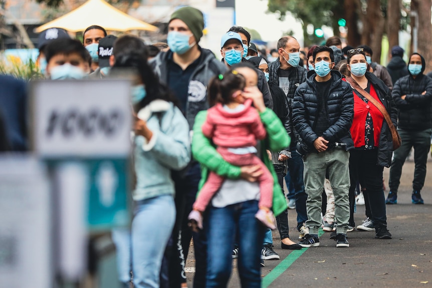 People wearing masks in a queue