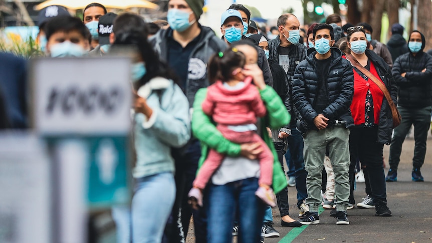 People wearing masks in a queue