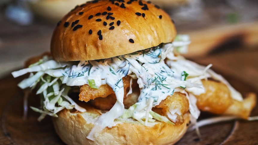 Fish burger with yoghurt tartare sauce, coleslaw and shallow-fried fish fillets, a fun family dinner.