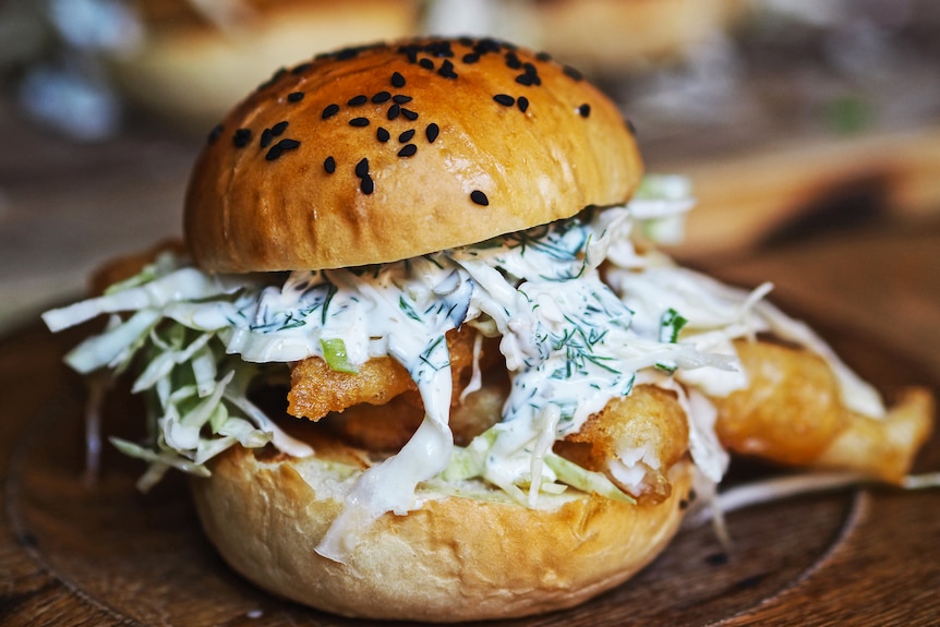 Fish burger with yoghurt tartare sauce, coleslaw and shallow-fried fish fillets, a fun family dinner.