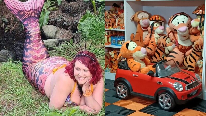 a woman with red hair lying on her chest wearing a mermaid's tail and a collection of plush tigers in a red toy car