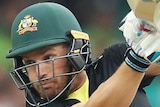 An Australian batsman watches a shot he plays to the off side against Pakistan in a Twenty20 international.