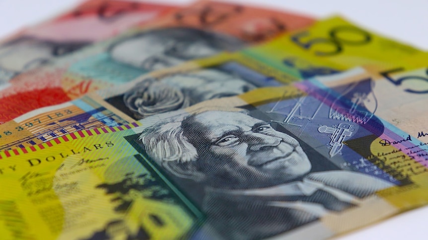 Four Australian bank notes are lined up against each other on a white background.