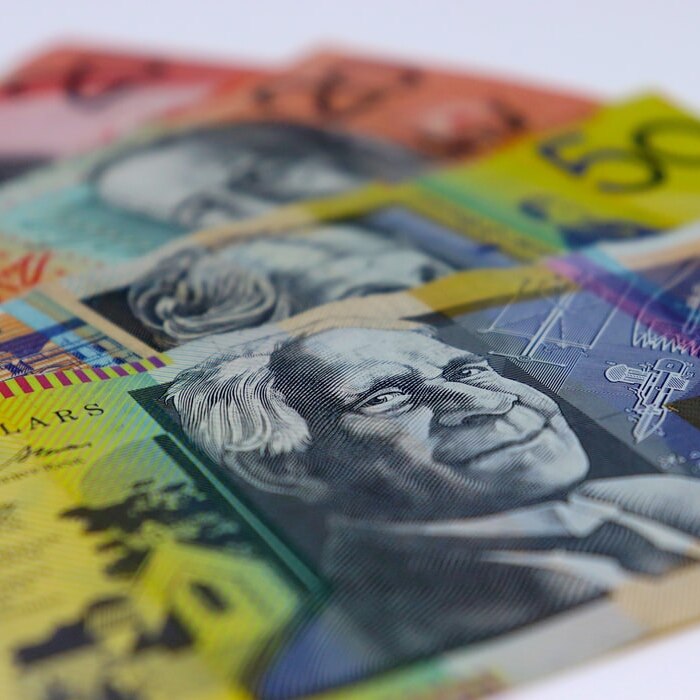 Four Australian bank notes are lined up against each other on a white background.