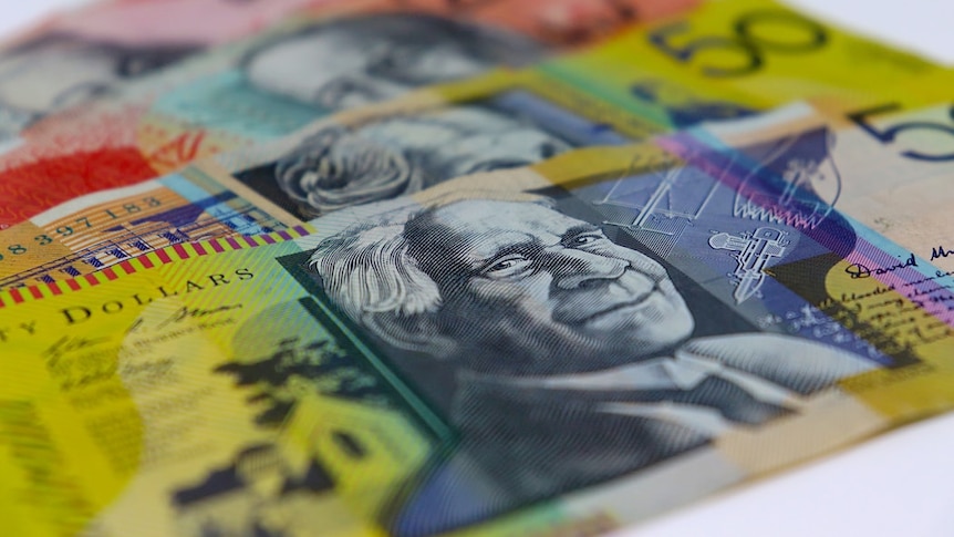 Four Australian bank notes are lined up against each other on a white background.