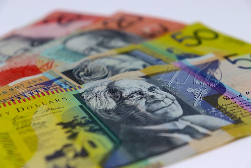 Four Australian bank notes are lined up against each other on a white background.