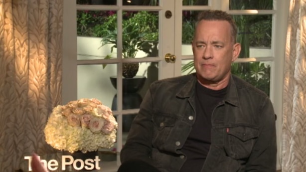 Tom Hanks sits in a chair during an interview about his new film The Post.