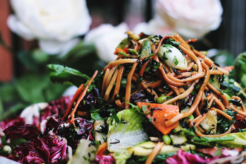 Vegetable salad with lettuce, carrot, cabbage and sweet potato to depict how to cook for vegans at Christmas.