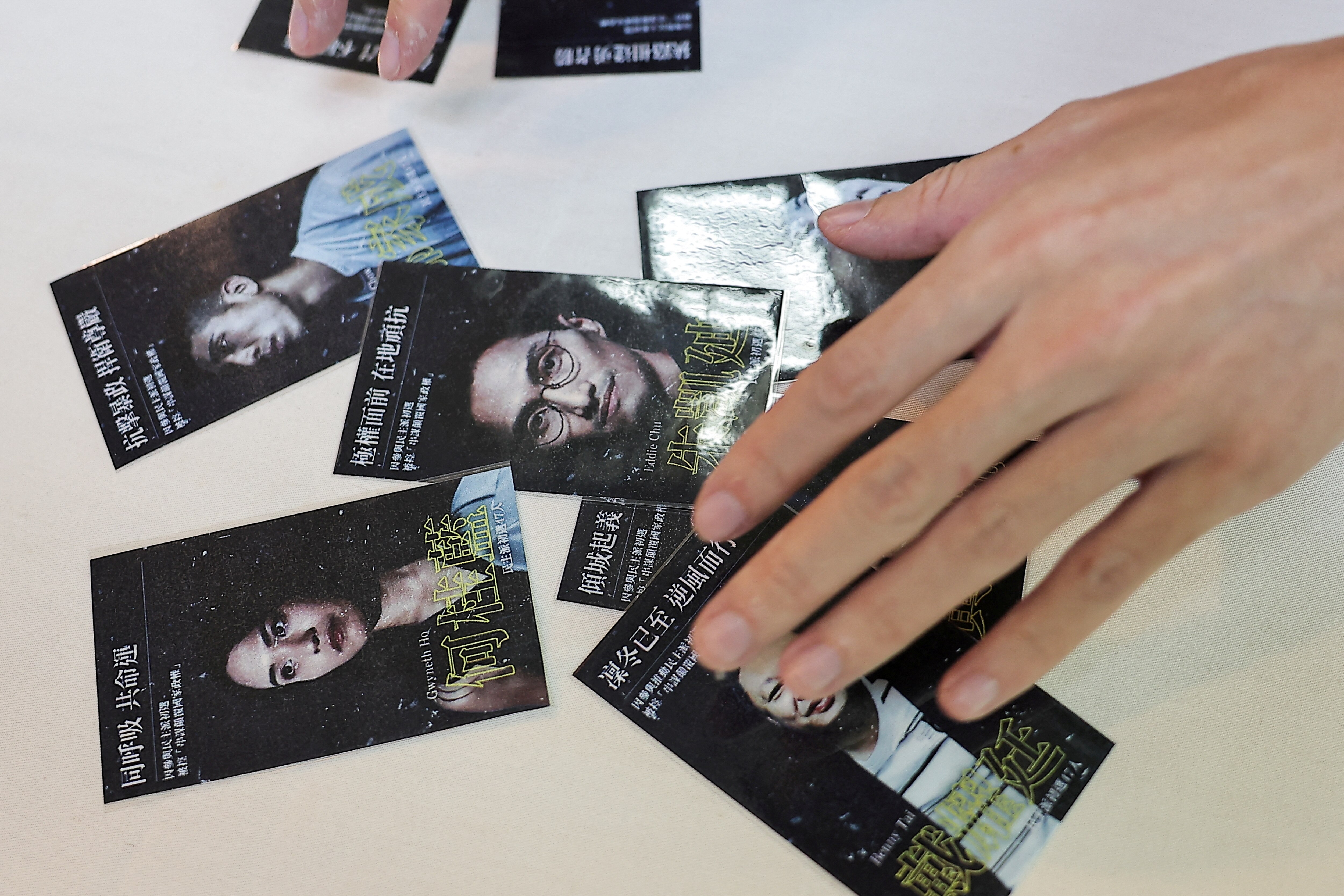 A hand rests over a group of photos 