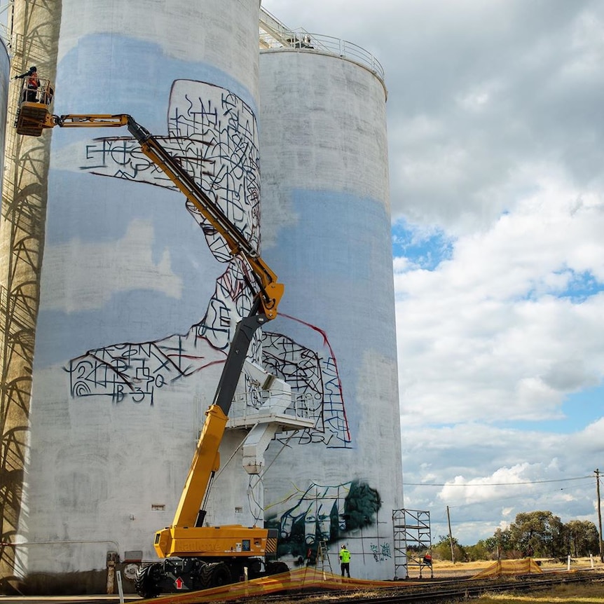 An outline of a boy painted on a silo