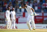 England's Alastair Cook celebrates a nine-wicket win over West Indies in the second Test in Grenada.