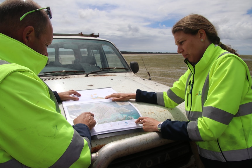 A man and a woman looking at a map.