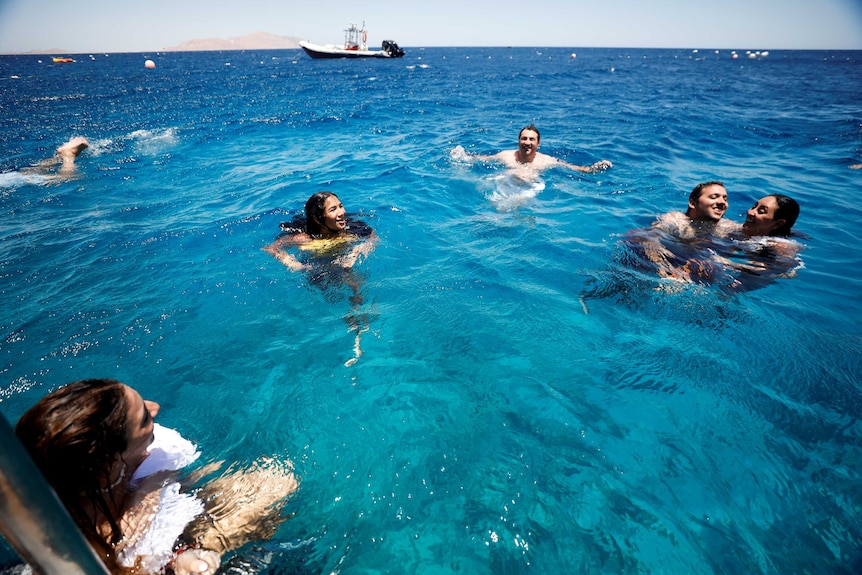 A group of people swimming in the Red Sea