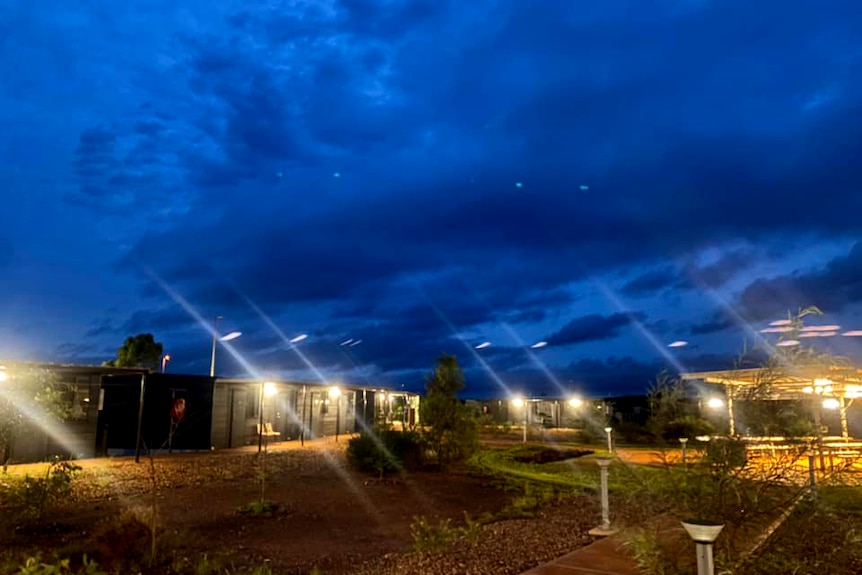 Dark skies over a mining camp accommodation at night.