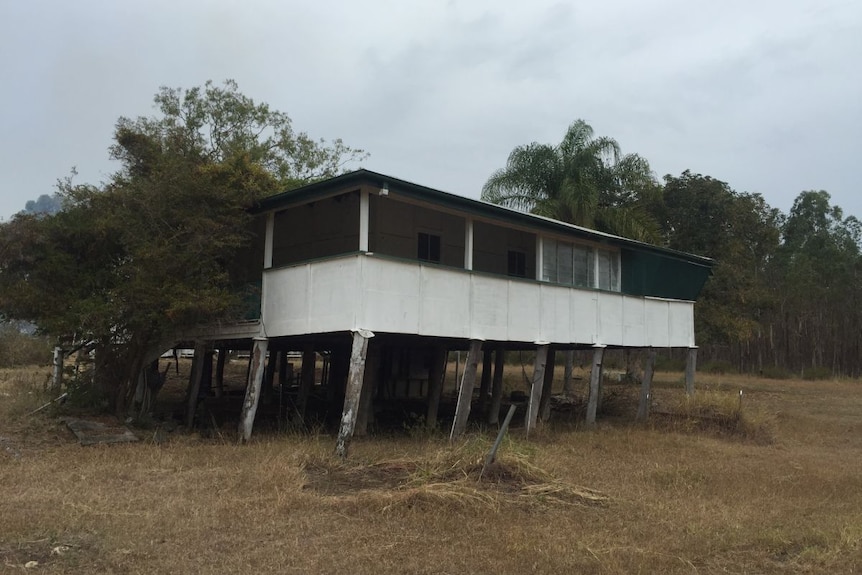 A dilapidated old farm house on rotting stilts.