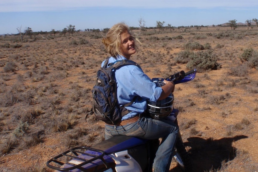 Tanja Ebert smiles while on a motorbike.