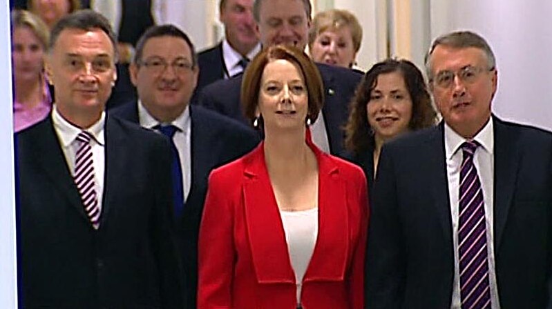 Julia Gillard leaves the caucus room at Parliament House in Canberra after being re-elected. (ABC TV)