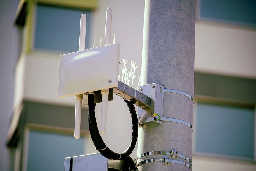 A Wifi box strapped to a pole.