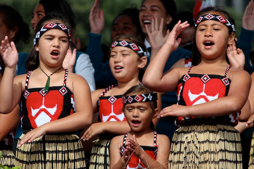 Four girls do a traditional Maori dance