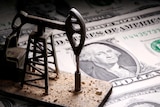 A 3D printed oil pump jack is placed on dollar banknotes in this illustration picture