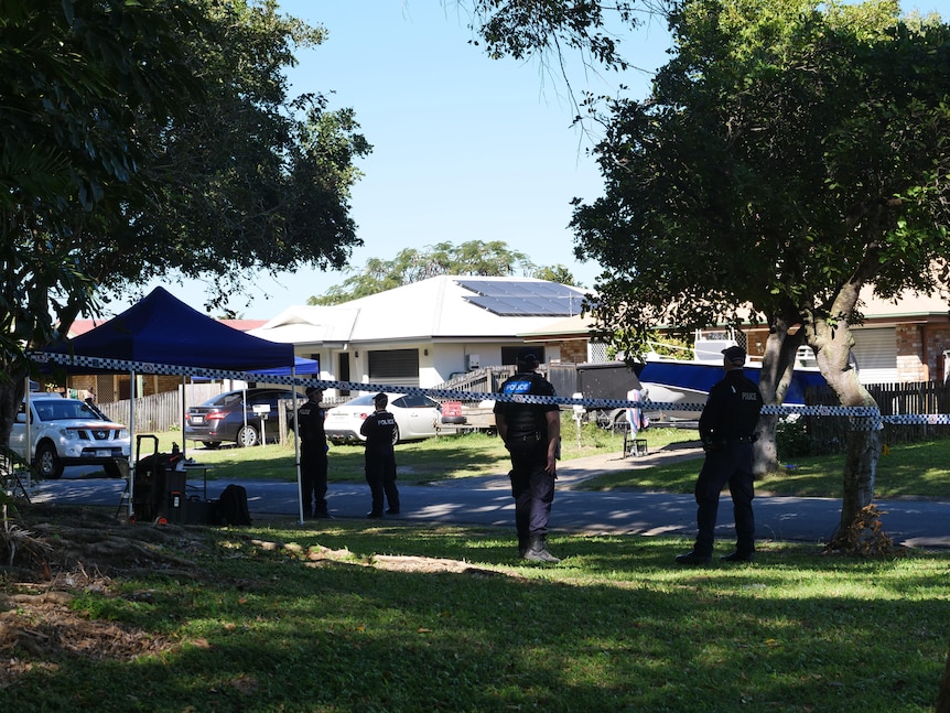 A wide scene of police in a suburban street 