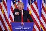 Donald Trump points and appears to argue with a CNN reporter at a press conference