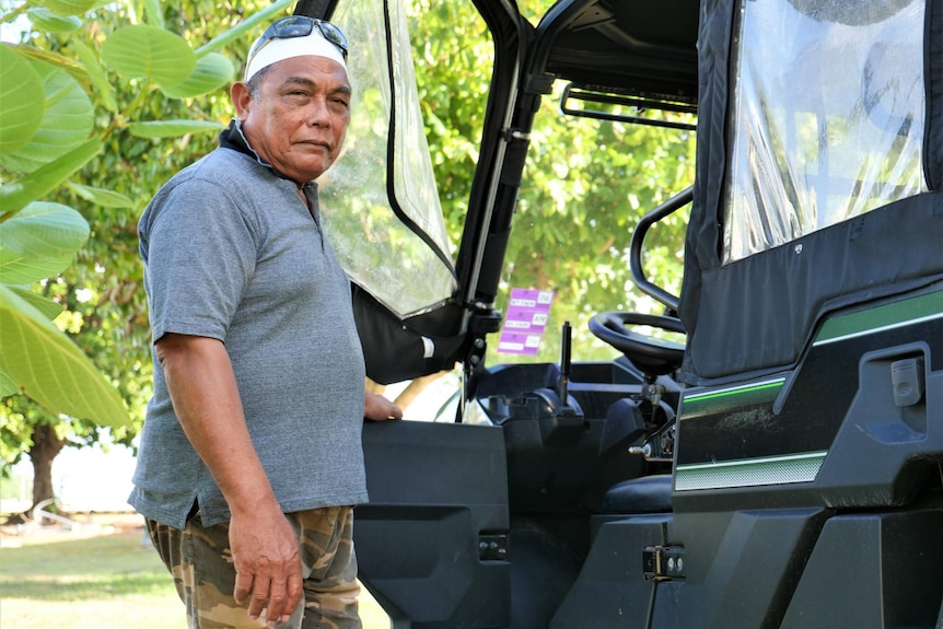 Home Island resident Nek Yusri stands by one of the all-terrain buggy vehicles commonly seen on Cocos.