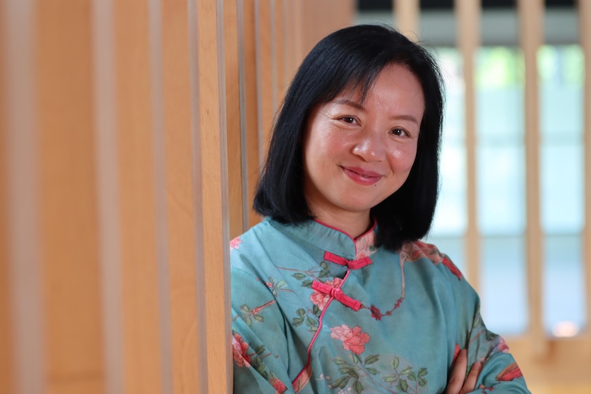 Shirley Chan smiles, wearing a blue top