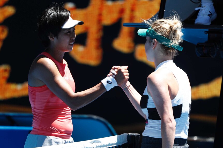 Elina Svitolina shakes hands with Zhang Shuai at the net at the Australian Open.