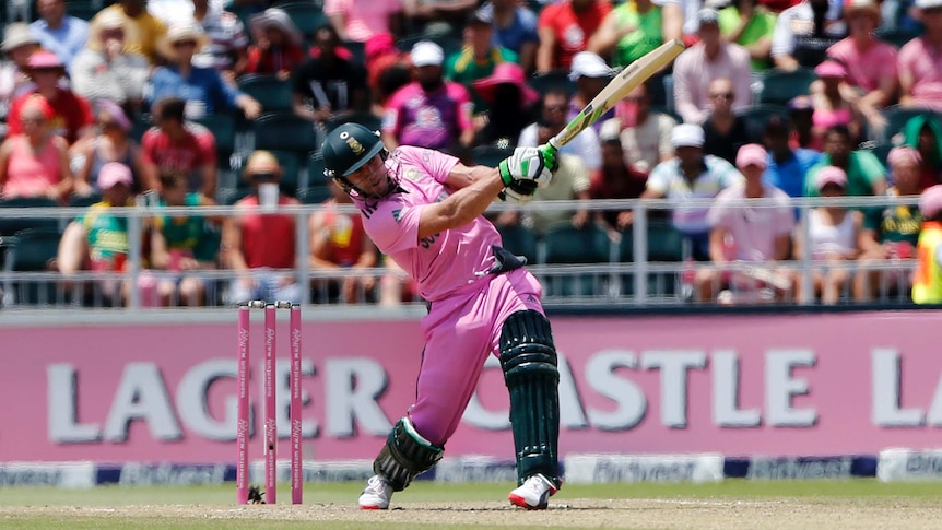 De Villiers swings his bat.