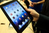 A customer looks at the the iPad released on March 16, 2012.