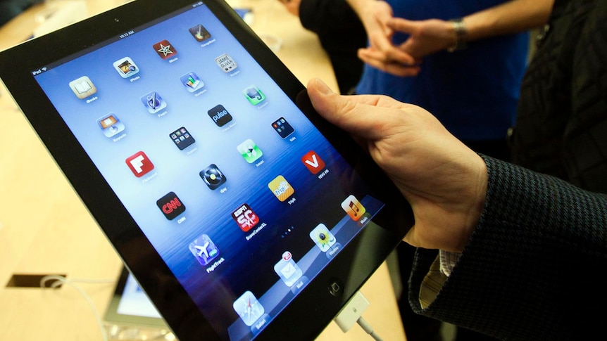 A customer looks at the the iPad released on March 16, 2012.