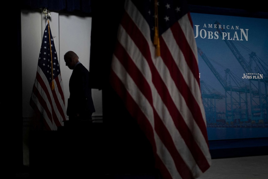 profile of President Biden as he leaves the podium. shaded.