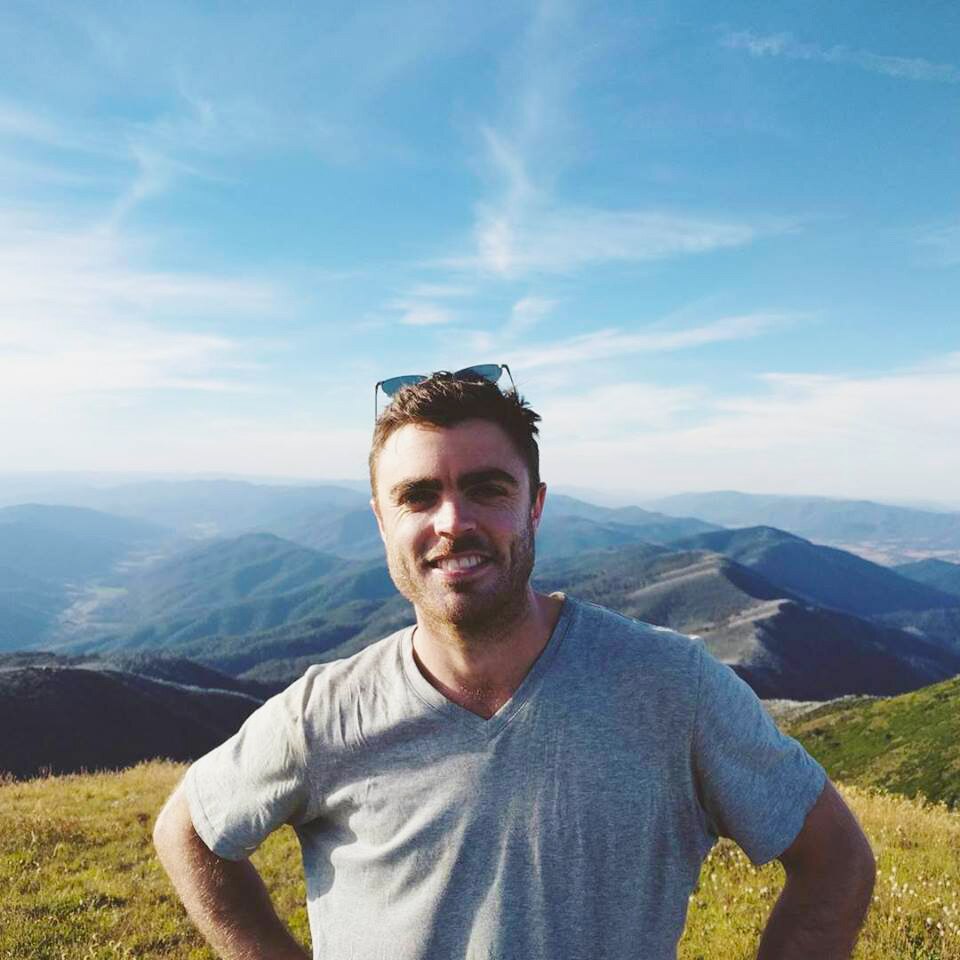 Ben Townsend poses for a photo on a mountain for a story about dealing with loneliness and learning from it.