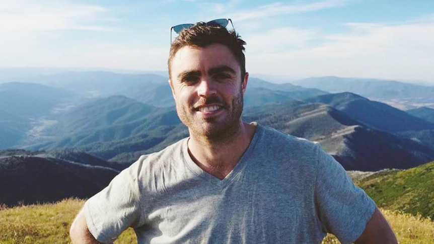 Ben Townsend poses for a photo on a mountain for a story about dealing with loneliness and learning from it.