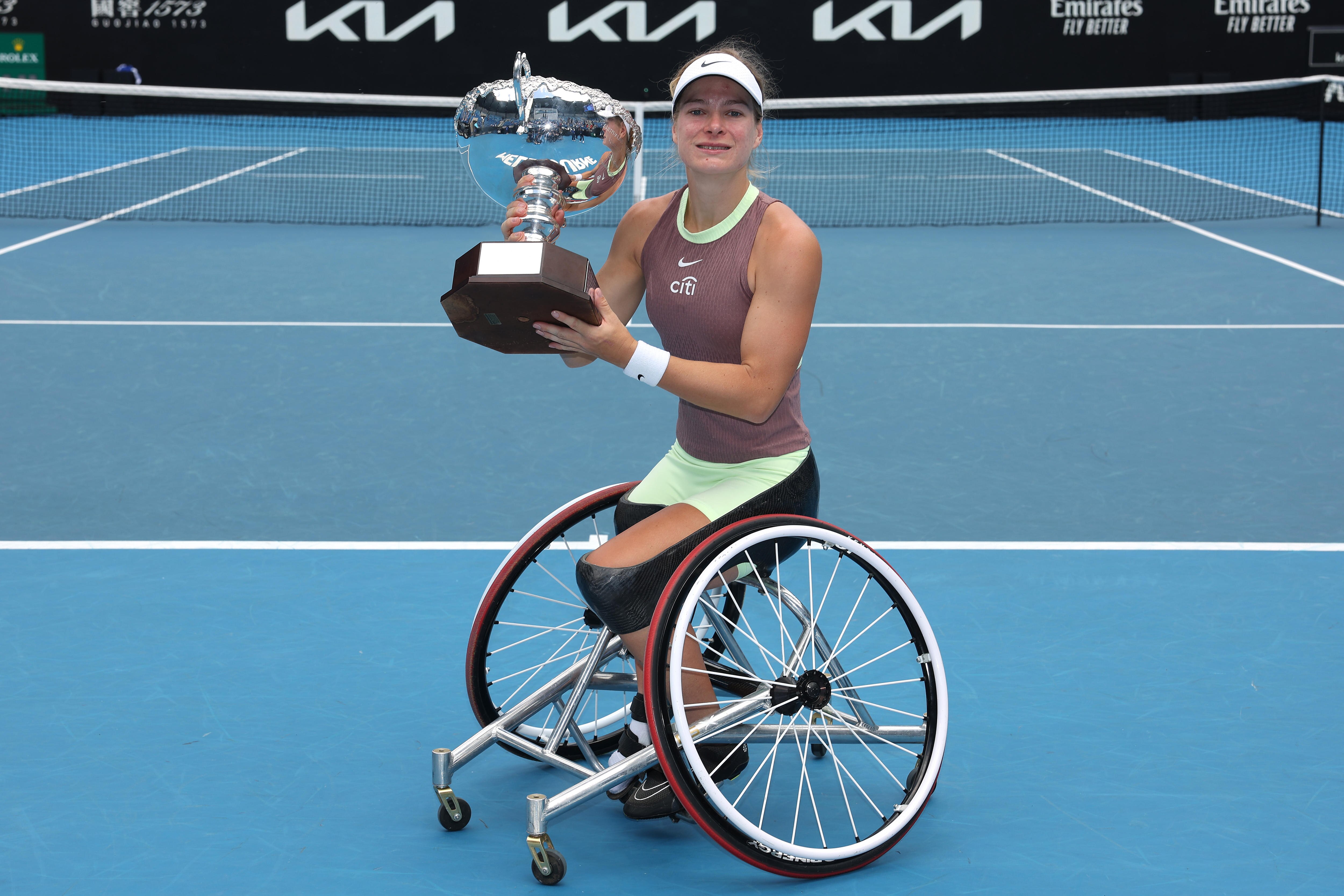 Diede de Groot holds the 2004 Australian Open trophy after winning the women's wheelchair singles final.