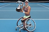 Diede de Groot holds the 2004 Australian Open trophy after winning the women's wheelchair singles final.