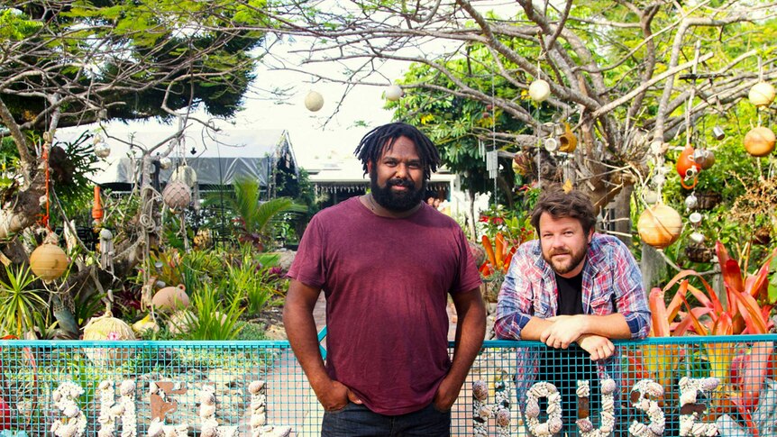Jeremy Marou and Tom Busby standing at a gate on Great Keppel Island.