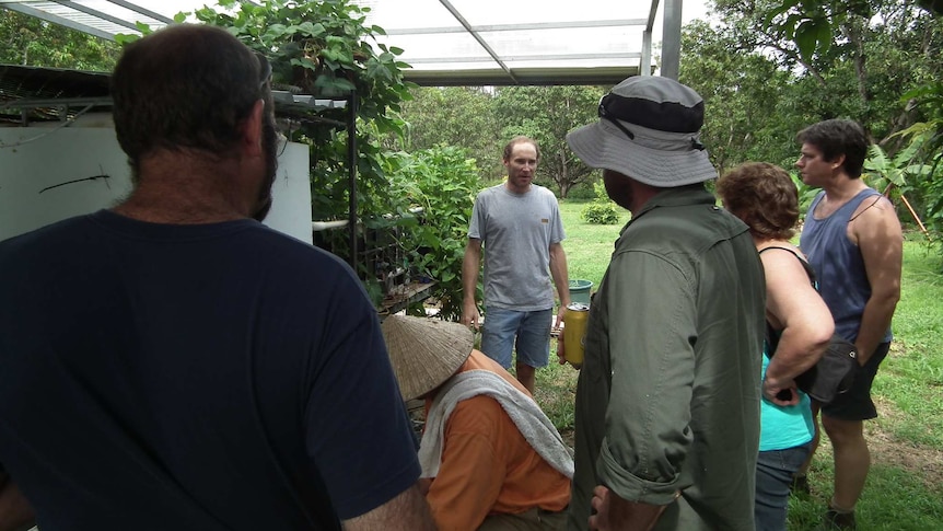 Hobby farmer David Mott talks to five other small farmers about his aquaponics set up on his farm in Darwin's rural area