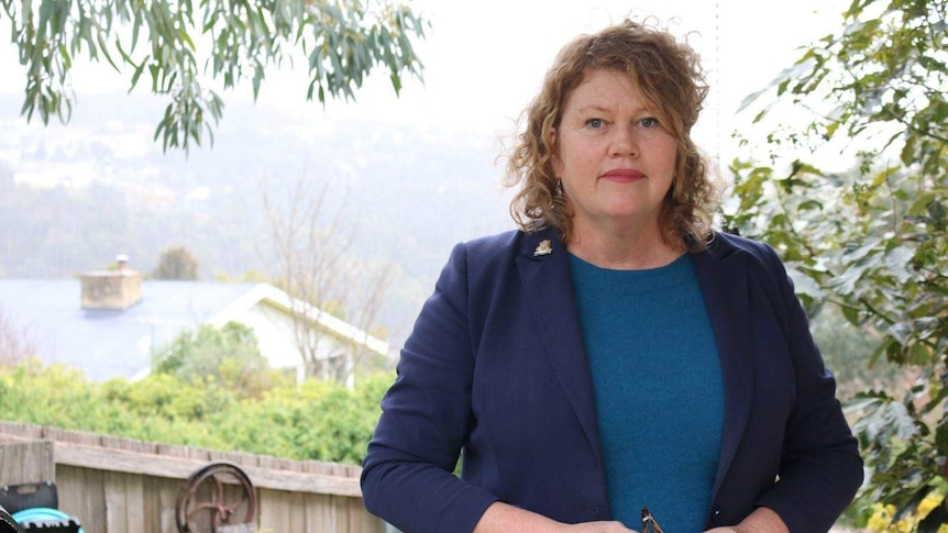 Anna Reynolds standing in her backyard.