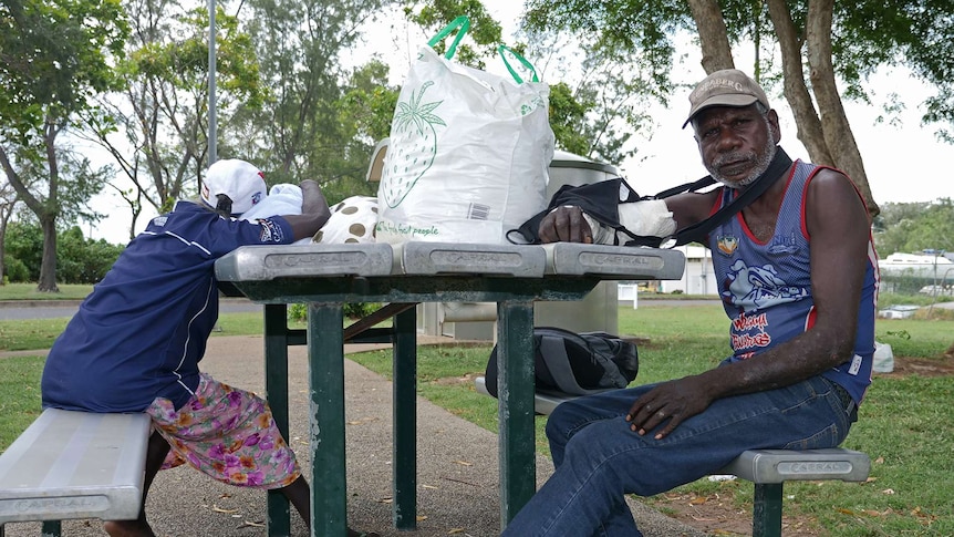 A photo of two long-grassers sitting at a table in Darwin.