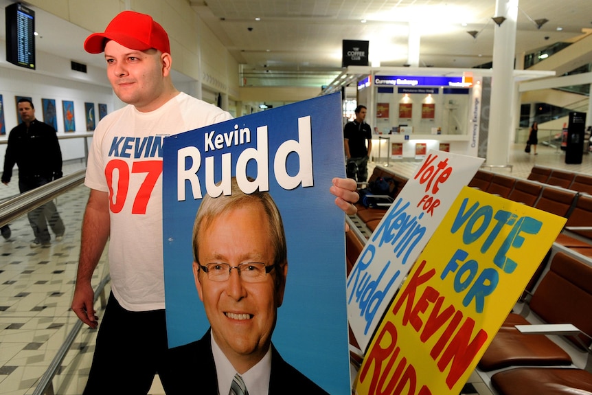 Kevin Rudd supporter Brad Newman waits for Mr Rudd to arrive at Brisbane Airport.