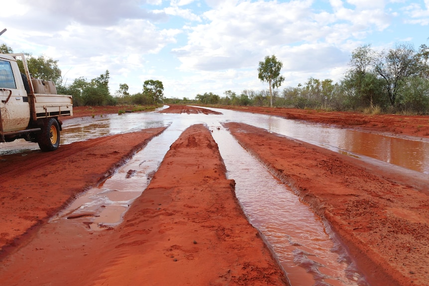 Flooded tracks of an outback red dirt track in Central Australia.