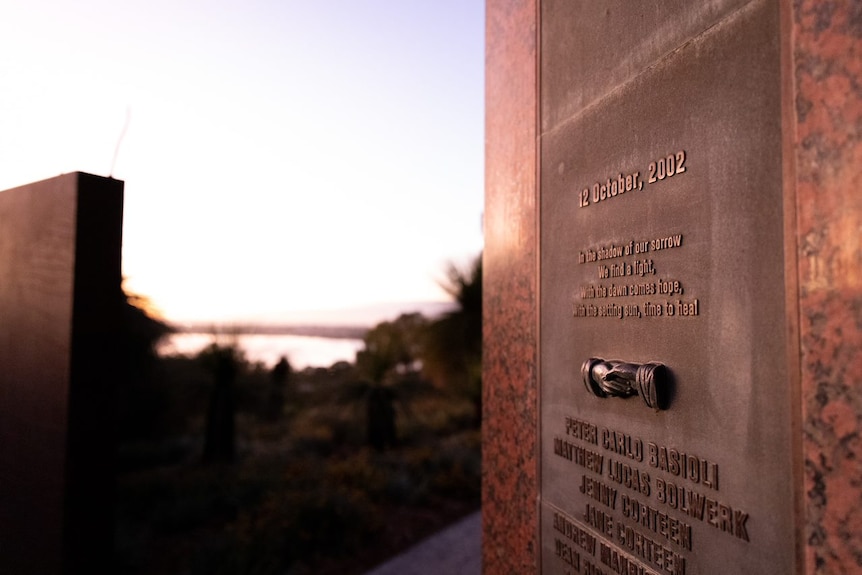 A memorial plaque at sunrise