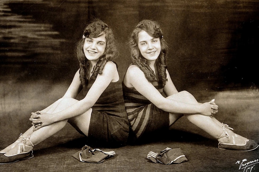 Conjoined twins Daisy and Violet Hilton sit side by side.