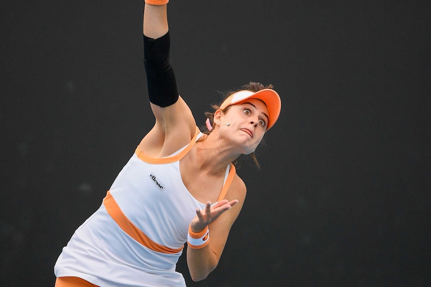 Kimberly Birrell connects with a ball while serving at the Australian Open.